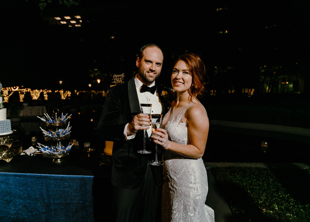Groom in a tuxedo toasting his bride at marie gabrielle dallas